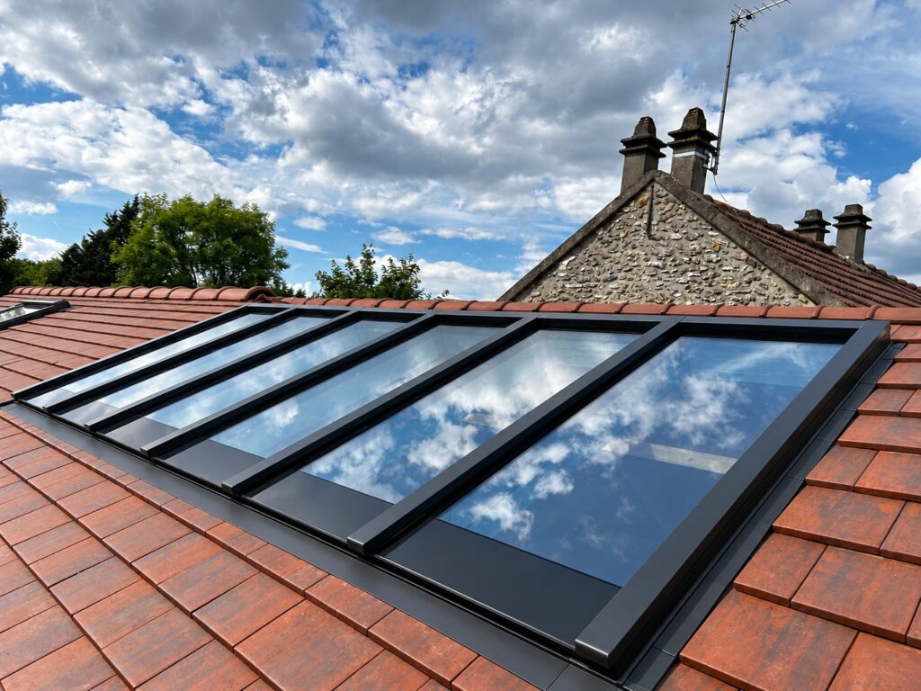 A glass and aluminium rooflight set into a tiled roof