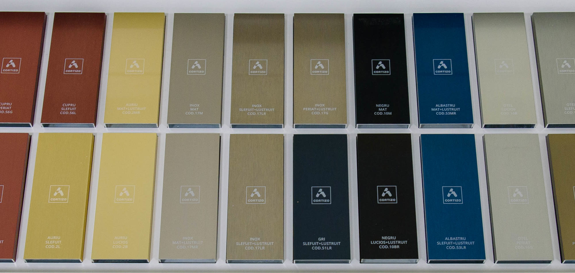 The physical sample board of CORTIZO anodised aluminium in the MCV ProTrust showroom: bronze, burgundy, copper, gold, stainless-steel effect, black, blue, grey and ivory